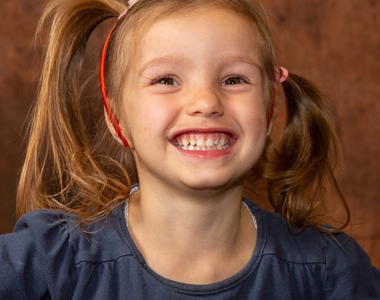 Cheeky smile by this pre-school girl in her school photography