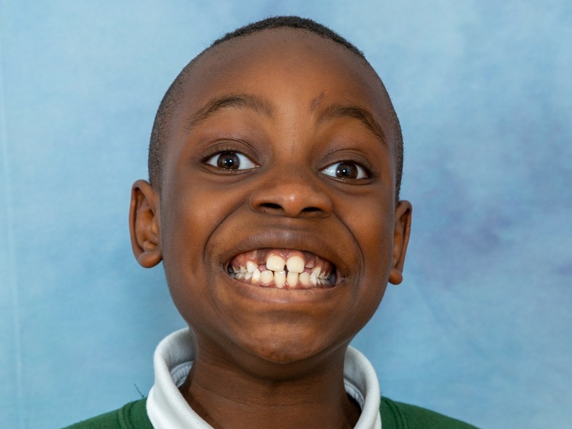 Happy young boy, with a gorgeous grin, happy and relaxed during our photography session