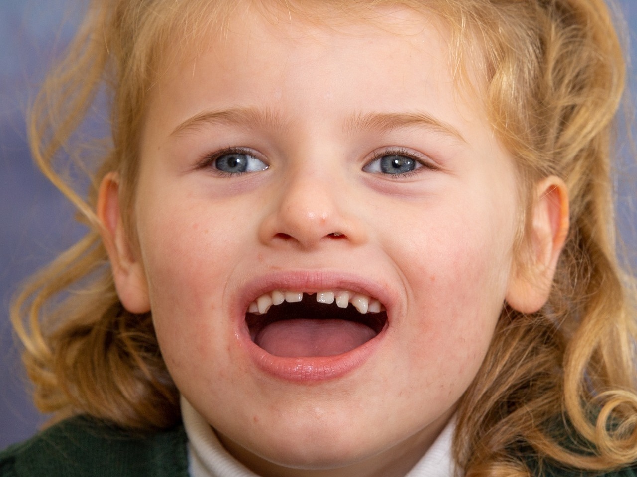 Pretty little girl with autism having her school photograph taken