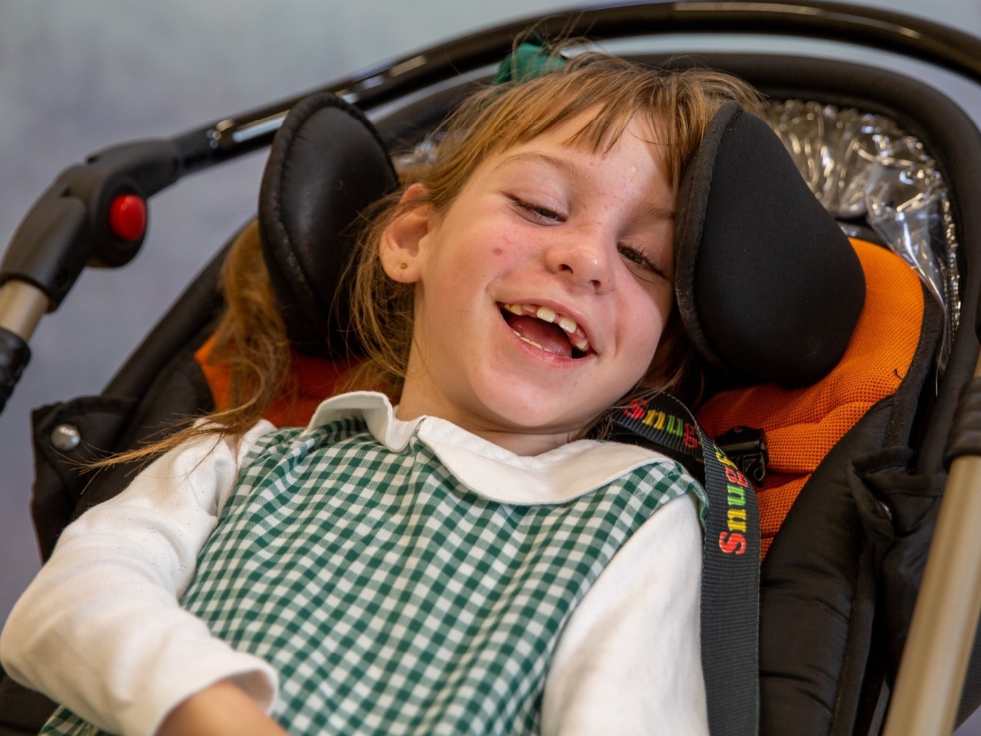 Stunning young disabled girl relaxed and smiling for her formal school photo session