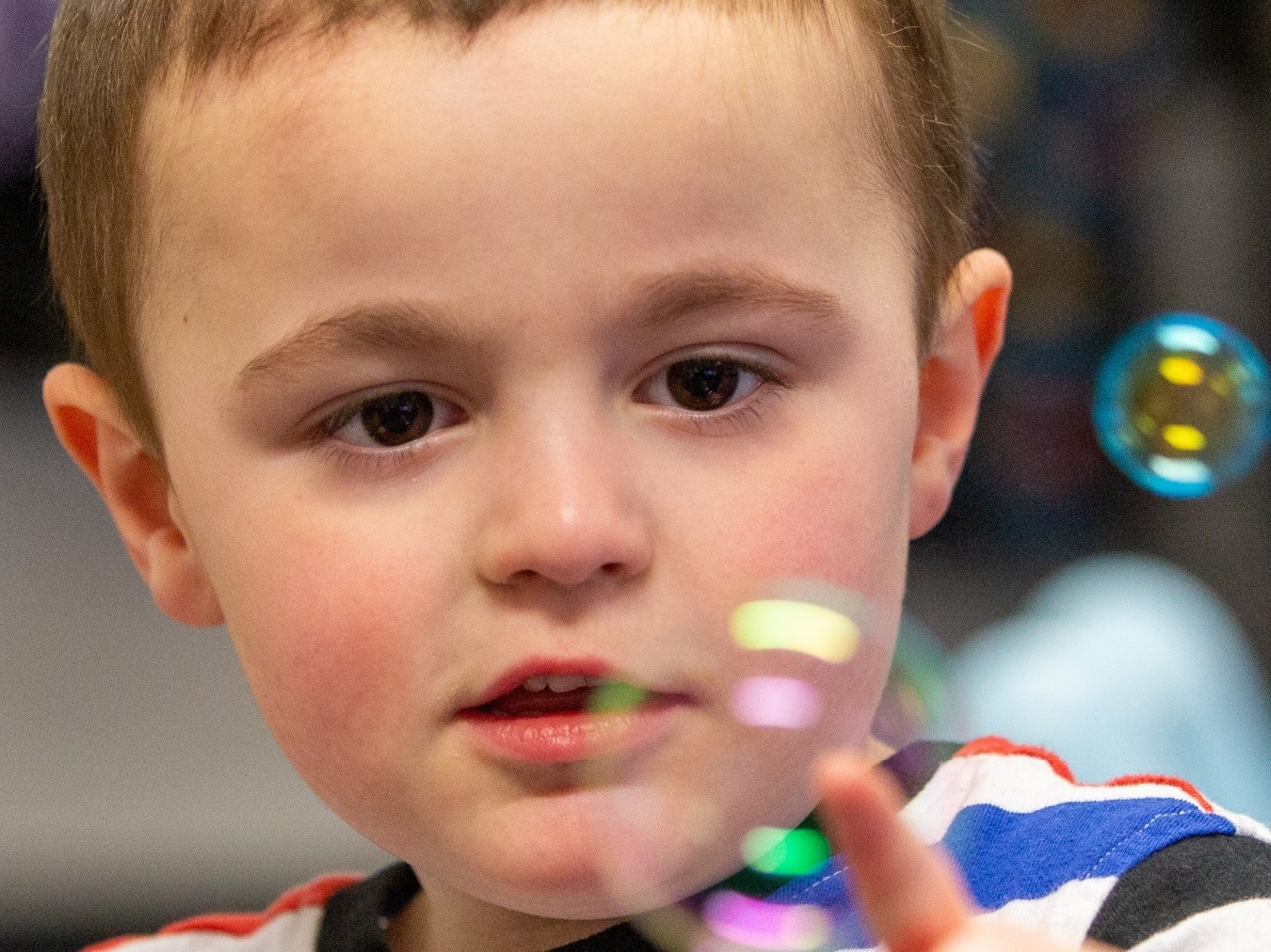 Bubbles, bubbles - a young boy with learning difficulties having his school photograph taken.