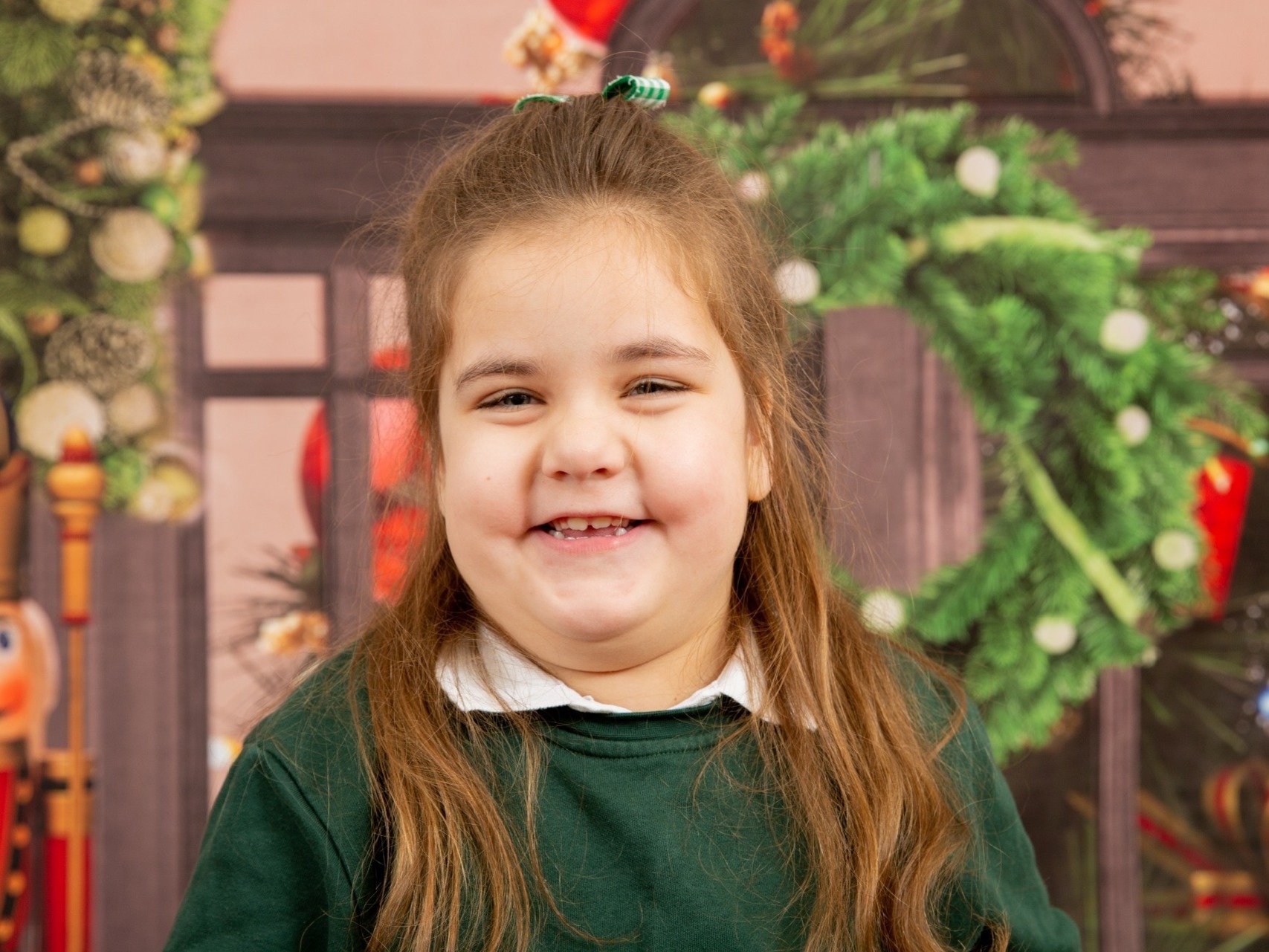 Gorgeous young girl with special needs having some festive fun in a formal Christmas portrait