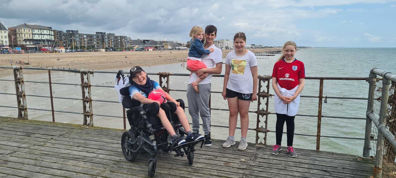 The Merry family enjoying a day out on the pier at Bognor Regis. George was able to access the whole pier area in his wheelchair!