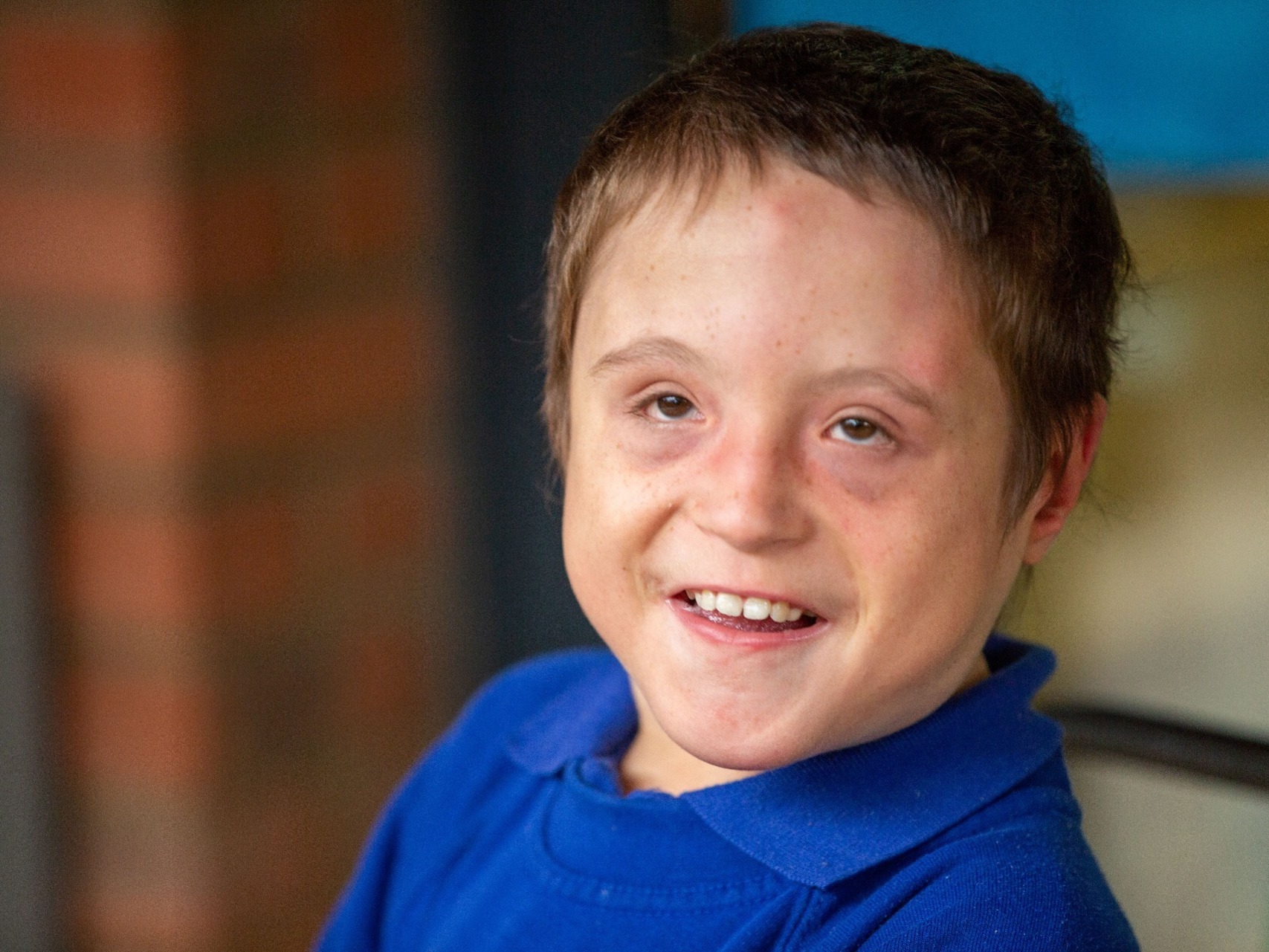 Young disabled boy with learning difficulties school portrait