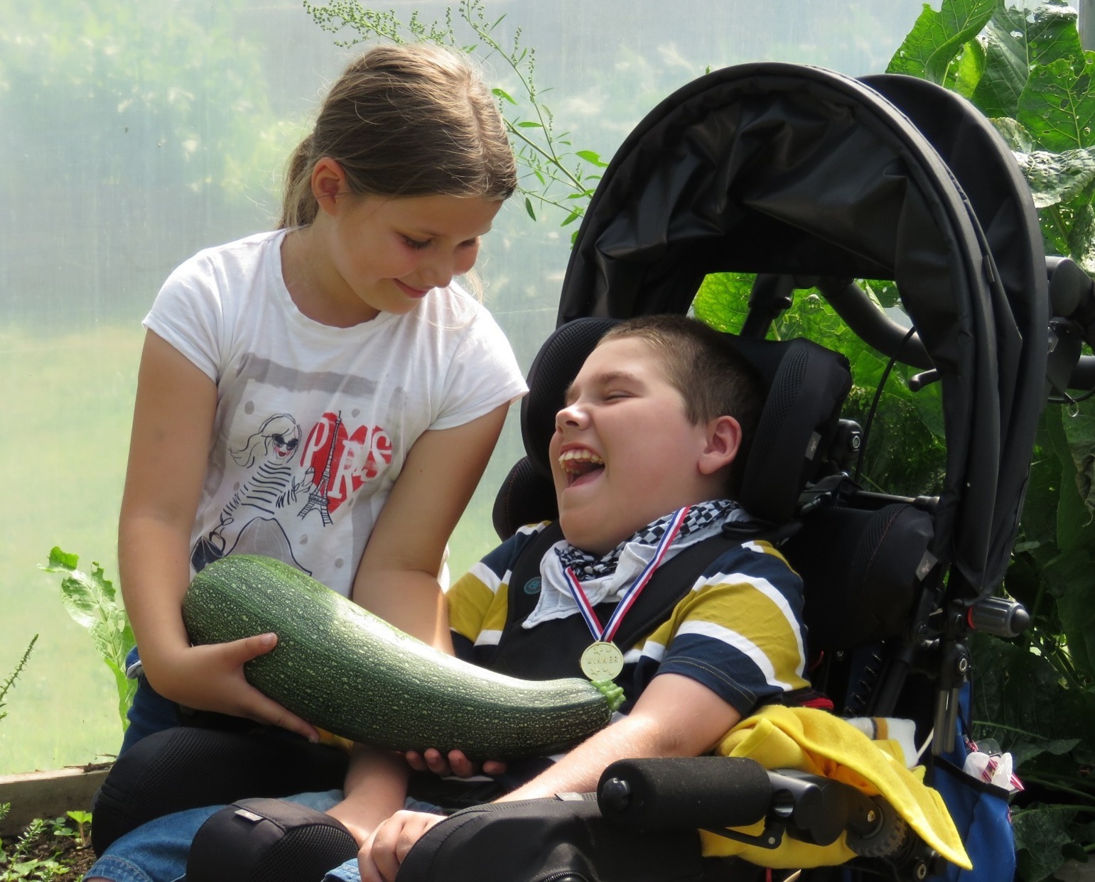 Scarlett Merry a young carer with her brother George who has quadriplegic cerebral palsy on holiday at Kerry's Farm Wales